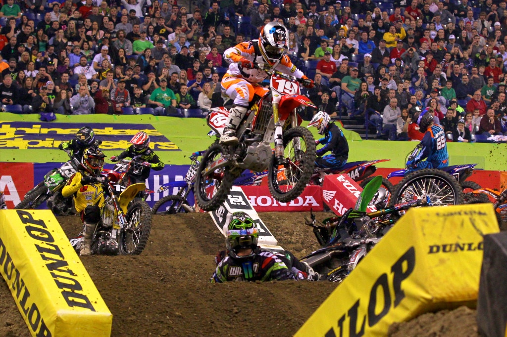 Still within the 1st lap, Dean Wilson had a hard kick out off the off-camber corner. He ended up slamming down onto the track hard and taking heavy injury. Thankfully all other riders were able to avoid hitting him. Blake Wharton is seen here seat hopping the jump to clear Wilson, with Will Hahn safely over him as well. I hope Wilson is able to recover from his injury quickly. He was clearly in a lot of pain when he rode by us standing trackside!